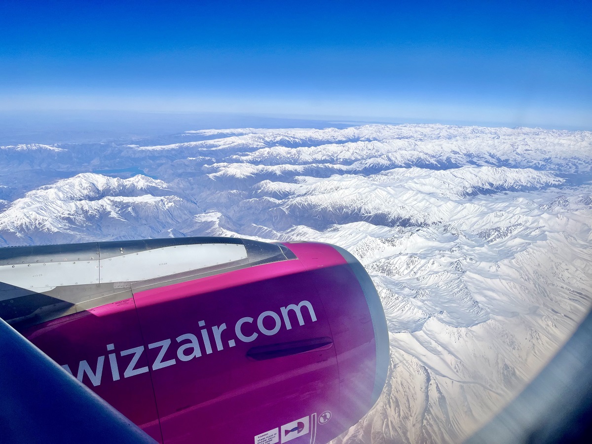 Flying with Wizz Air over the snow-capped mountains in Central Asia